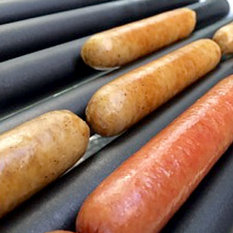 Hot dogs and sausages on a roller grill.